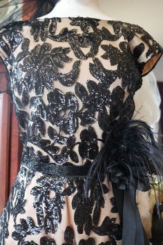 a black and white dress with feathers on it