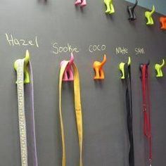 a chalkboard with several different colored ribbons hanging on it