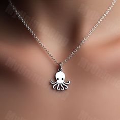 Available in multiple sizes and metal options ✨ Chain not included ❌ Gift packaging included 💕 🐙 Elevate your style with our minimalist Octopus Charm Pendant! 🌟 🌿 Crafted with sleek lines and understated elegance, this charming pendant is perfect for those who appreciate simplicity and the natural beauty of octopuses. 🍃 💫 Made from high-quality materials, the minimalist octopus design exudes a sense of quiet sophistication, making it a versatile accessory for any occasion. 🌟 🎁 Whether you're treating yourself or surprising a loved one, this octopus charm pendant is a timeless addition to any jewelry collection. 💍 🚀 Embrace minimalist chic with our Octopus Charm Pendant and add a touch of understated charm to your everyday look! Shop now and let your style shine with simplicity. ✨ Octopus Gift, Octopus Jewelry, Schmuck Gold, Octopus Pendant, Octopus Design, Minimalist Chic, Pendant Gold, Understated Elegance, Jewelry Gold