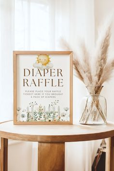 there is a sign that says diaper raffle next to a vase with some dry grass in it