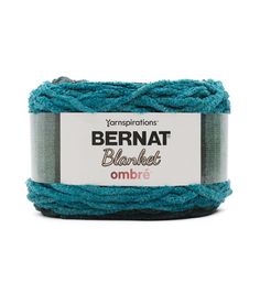 yarn ball in blue and grey with the label bernat blanket ombre on it