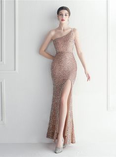 In spellbinding gold, this long mermaid prom dress is a vision of modern-day elegance entwined with a whimsical allure. The one-shoulder neckline, adorned with a beading tassel, is a tribute to contemporary finesse, crafting a sophisticated profile. The dress descends gracefully, with sequins shimmering in unison from the neckline to the floor-length hem, destined for admiration at proms, luxurious galas, and other black-tie events. The sleeveless ensemble is perfectly balanced with a zipper-up back, ensuring a seamless fit. A daring high slit adorns one side, allowing for graceful movement amidst the tranquil shimmer. Capture the essence of the night in this white long beaded mermaid prom gown, a beautiful blend of modern design and timeless elegance. Prom Dresses Long Mermaid, Tulle Flower Girl, Flower Girl Dresses Tulle, Sequin Party Dress, Women's Evening Dresses, Sequin Beading, Prom Party, Mermaid Prom Dresses, Long Prom Dress