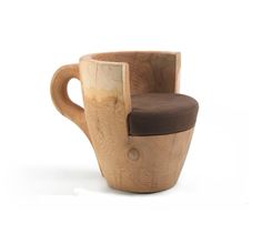 two wooden cups sitting next to each other on top of a white surface with one cup in the middle