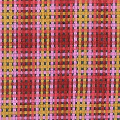 an orange, pink and yellow checkered fabric with some black dots on the side