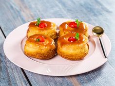 three small pastries on a plate with a spoon