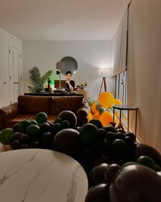 a living room filled with furniture and lots of balloons