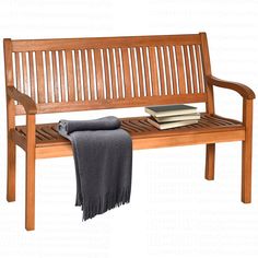 a wooden bench sitting next to a stack of books