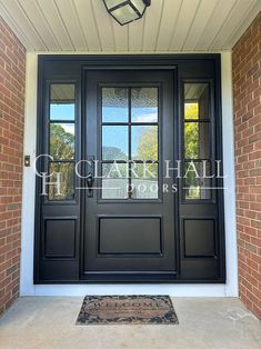 a black front door with two sidelights