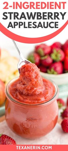 two ingredient strawberry apple sauce in a glass jar with a spoon and strawberries on the side