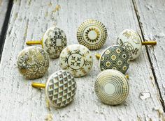 an assortment of ceramic knobs sitting on top of a wooden surface