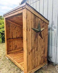 a wooden storage shed with a star on the side