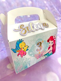 a box with the name ariel on it and an image of little mermaids under the sea