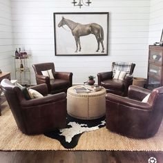 a living room filled with furniture and a horse painting on the wall above it's head