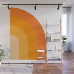 an orange and white wall mural in a living room with wooden flooring, bookshelf and plant