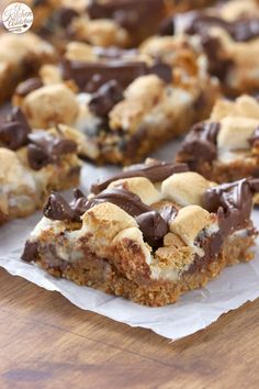 chocolate chip cookie bars with marshmallows and chocolate chips on top, sitting on parchment paper