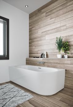 a bathroom with a large white tub next to a window and wooden flooring on the walls