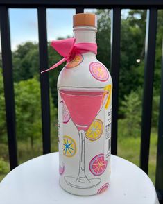 a painted bottle with a pink bow on it