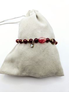 Beautiful Beaded Stretchy Bracelet with Burgundy, Rose & Gold beads.  Fits most adult wrist.    **Although I do my best to capture the most accurate photographs, please be aware that the color of an item or items may appear different in person due to the lighting in the photographs** Burgundy Round Beads Bracelet As Gift, Elegant Red Gemstone Beads Stretch Bracelet, Adjustable Burgundy Round Bead Bracelets, Red Adjustable Stretch Bracelet, Personalized, Casual Red Hand-strung Stretch Bracelet, Red Beaded Bracelet, Rose Gold Beads, Stretchy Bracelets, Tampa Fl