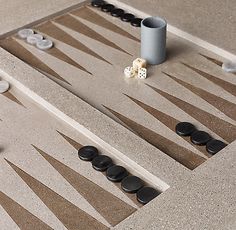 two pieces of wood sit on top of a game board with black and white tiles