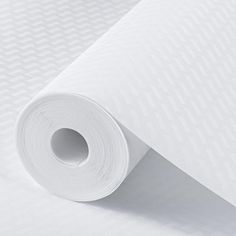 a roll of white paper sitting on top of a table