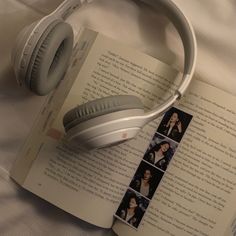 an open book with headphones on top of it