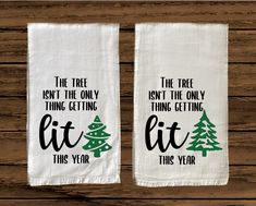 two tea towels with the words, the tree isn't the only thing getting lit this year