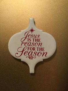 a white ornament with the words jesus is the reason for the season on it