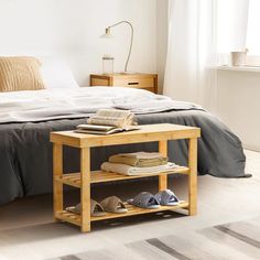 a bedroom with a bed, nightstand and shoes on the floor