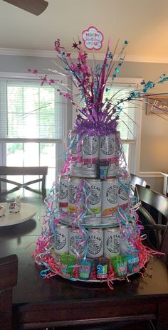 a cake made to look like a can tree with pink and blue streamers on it