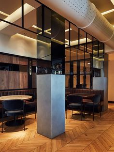 the interior of a modern restaurant with wooden flooring