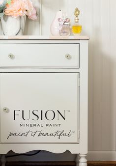 a white dresser with the word fusion painted on it's front and side panels