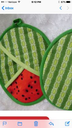 two watermelon shaped pot holders with green trims and red spots on them