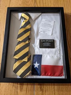 an american flag tie and other items in a shadow box