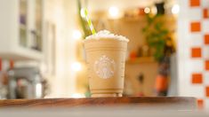 a starbucks drink sitting on top of a wooden table