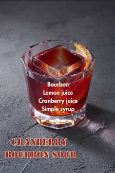 the cranberry bourbon sour is served in a glass with an orange slice on top