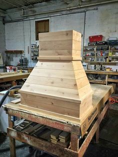 a wooden stove top sitting on top of a workbench