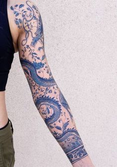 a woman with a dragon tattoo on her arm