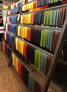 there are many different colored umbrellas on the shelves in this store that is selling them