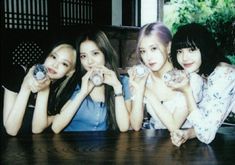 three girls are posing for the camera with their hands together