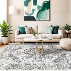 a living room with white couches and green accents on the walls, rugs and lamps