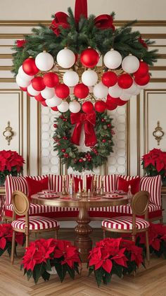 a christmas table setting with poinsettis and wreath