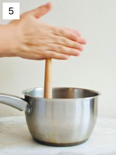 a person is stirring something in a saucepan