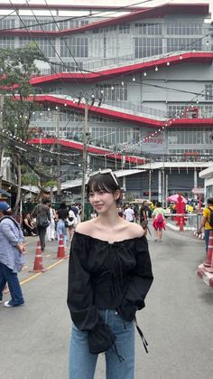 a woman standing in the middle of a street