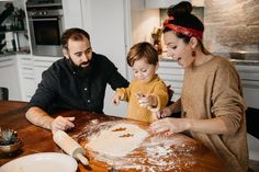 a man, woman and child are making dough