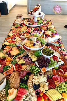 a long table filled with lots of different types of food on top of each other