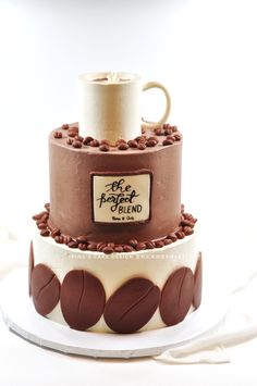 two tiered cake decorated with coffee beans and the words, one for each island