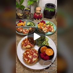 a table topped with plates filled with pizza and fruit