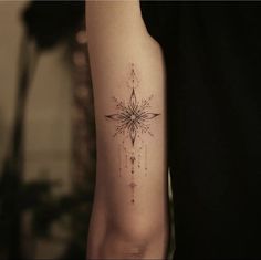 a woman's arm with a star tattoo on it