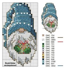 a cross stitch christmas ornament with a santa hat