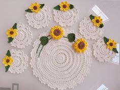 crocheted doily with sunflowers and leaves on it